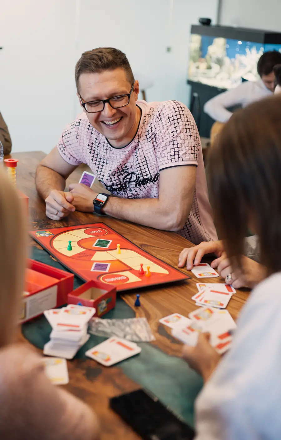 VL team member laughing over a board game at the office