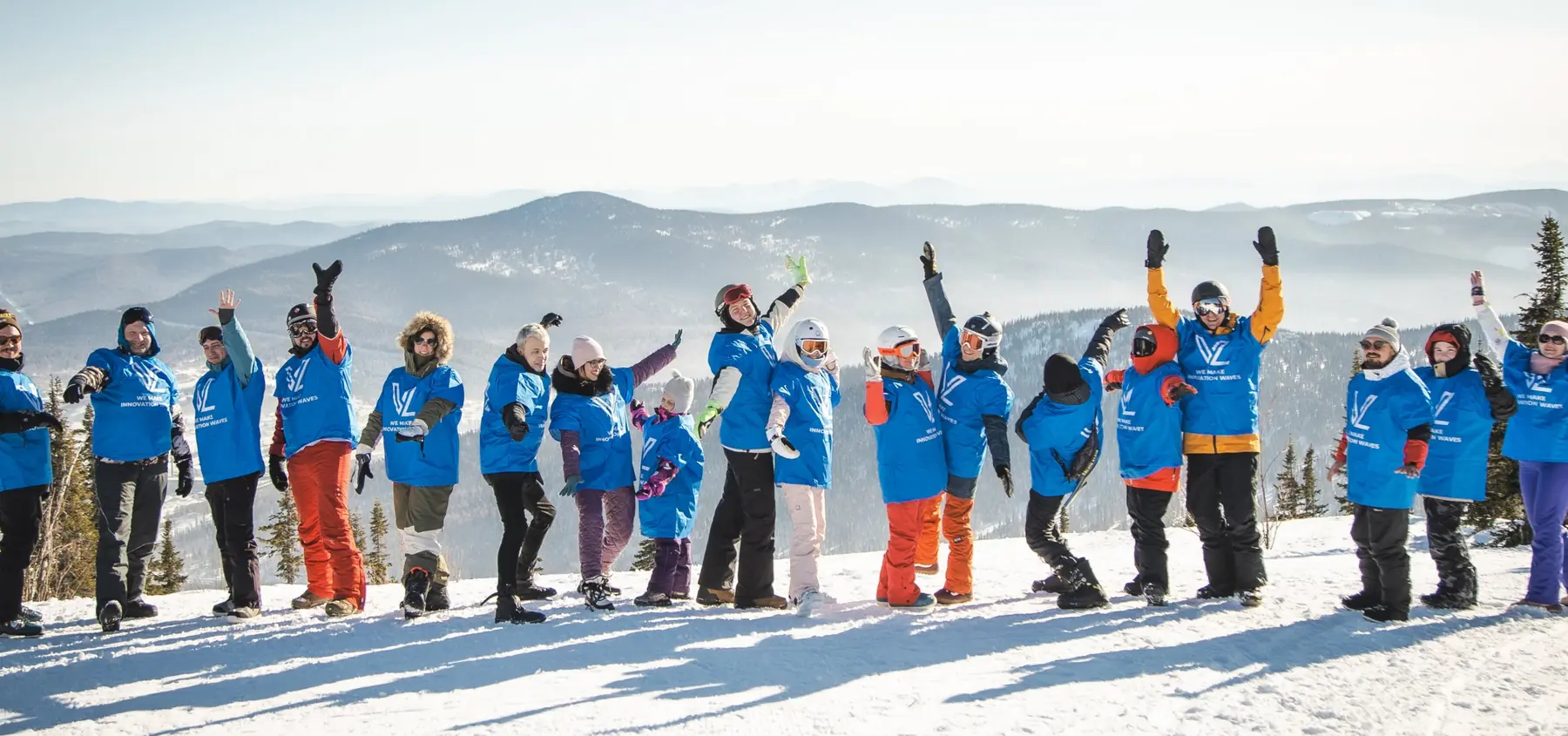 VL team in branded T-shirts at the top of a ski slope