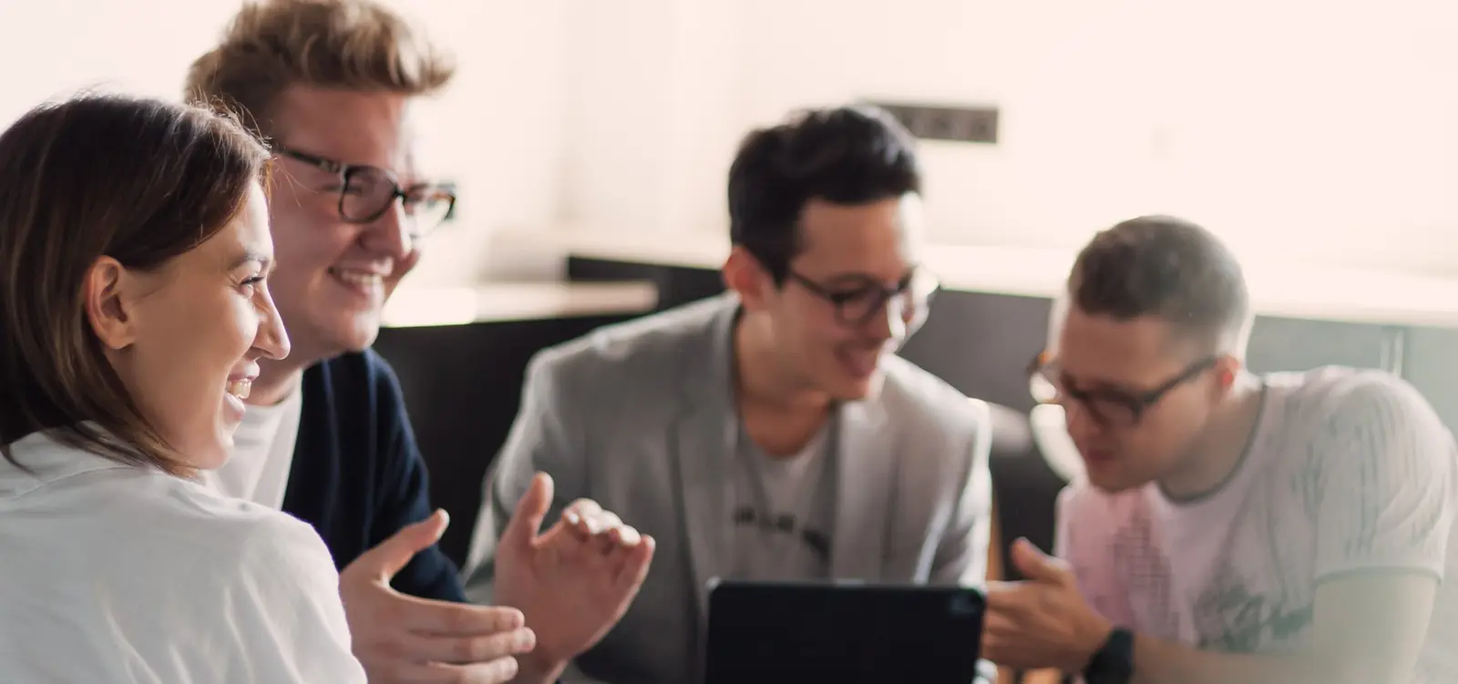 VL team members discussing a project over a tablet